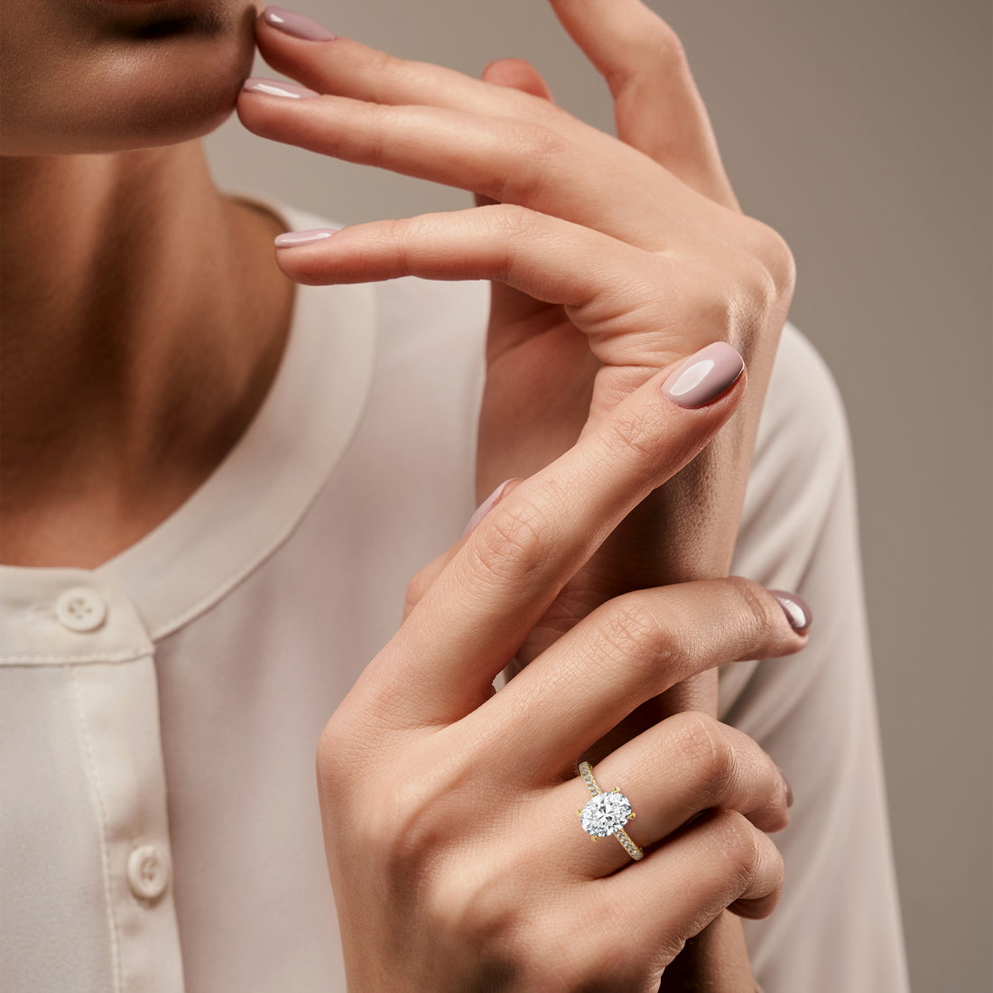 Oval pavé diamond engagement ring in Yellow Gold – lifestyle hand view